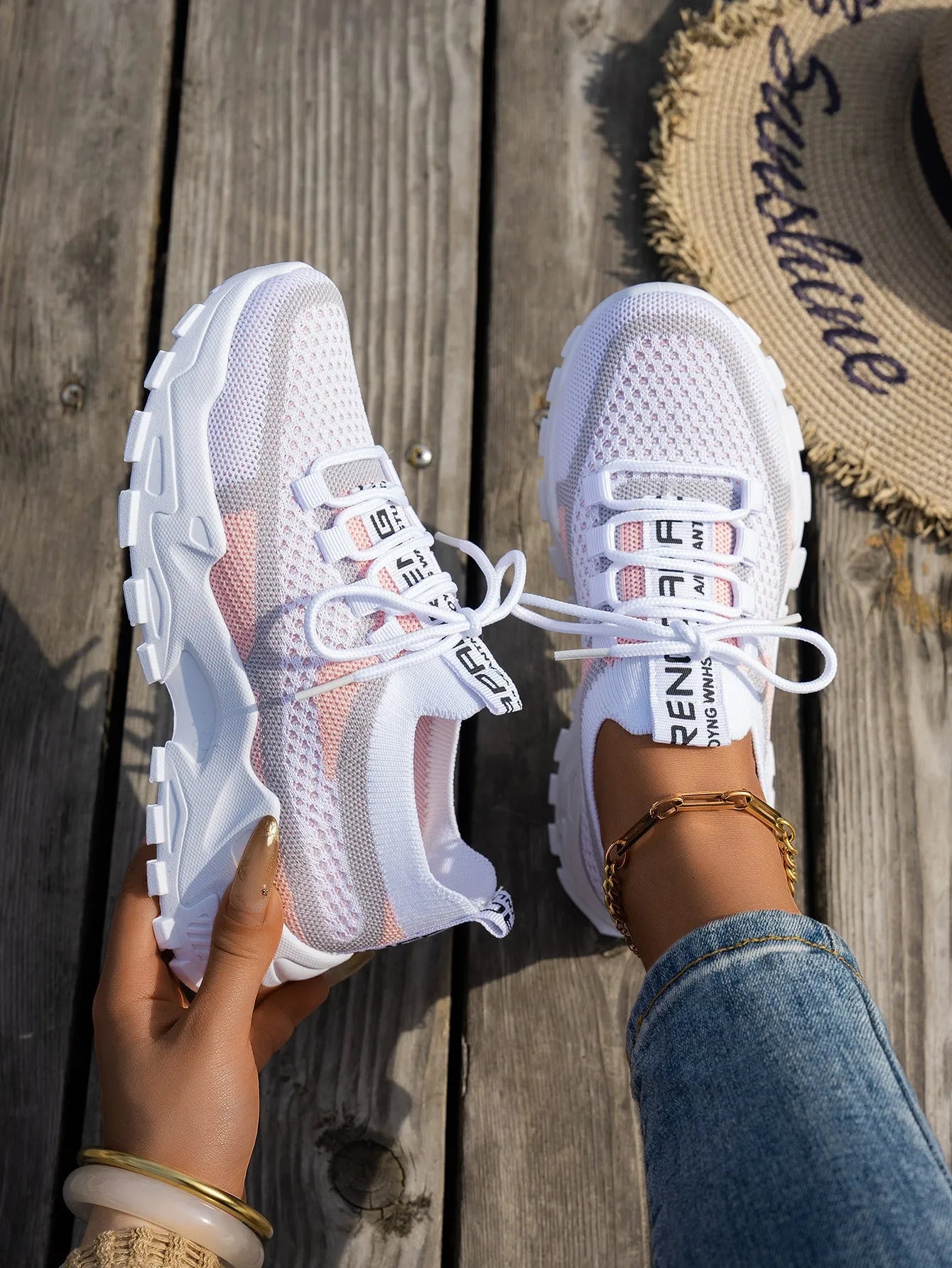 Women's lace-up Flyknit mesh sneakers in a grey colour combination with a round toe and flat rubber sole.