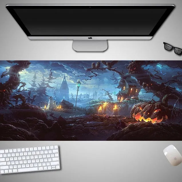Oversized Halloween graphic cloth mouse pad on a desk, showing non-slip rubber base.