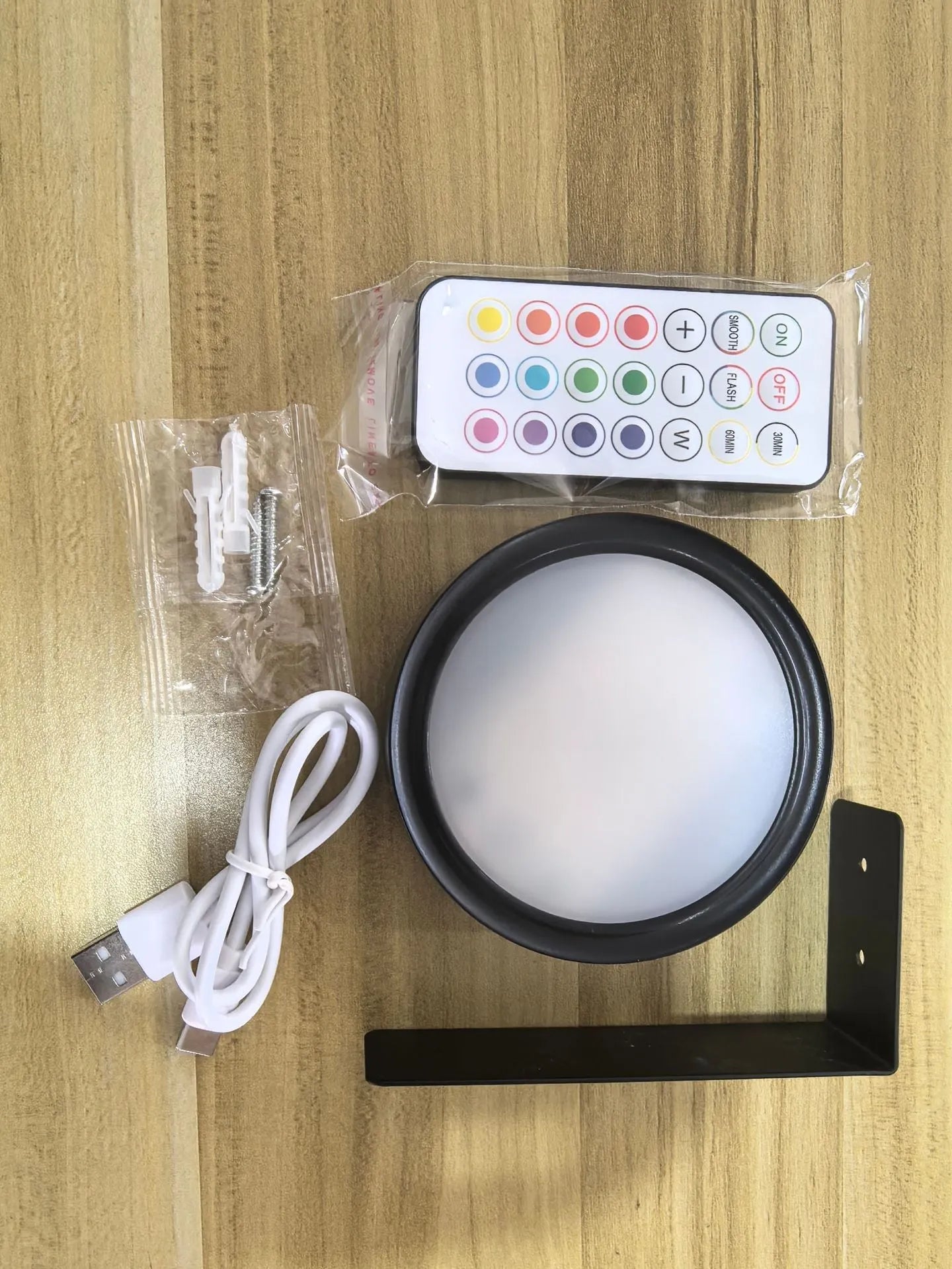 Wireless LED painting lamp with a magnetic mounting belt and remote control in black finish.