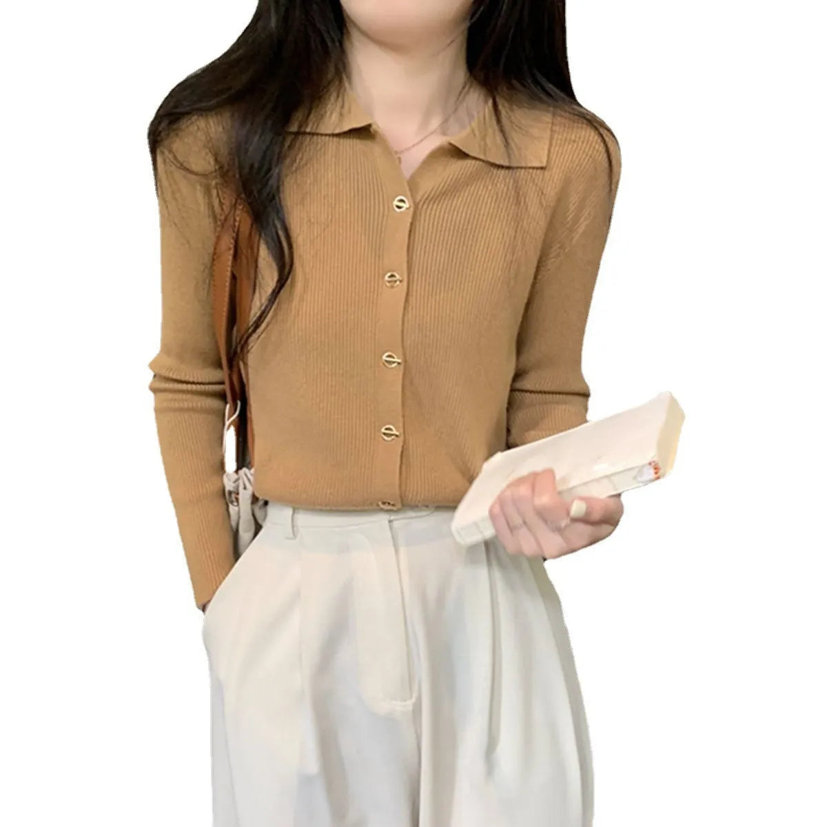 Loose fit knitted cardigan in beige, shown worn open as a long-sleeved top
