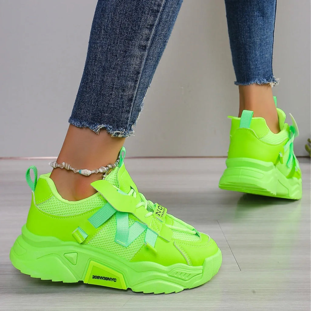 Women's platform mesh dad sports trainer in animal pattern, showing lace-up front and height-increasing sole.