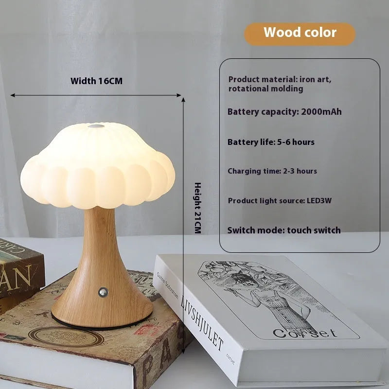 Small mushroom-shaped touch night lamp in wood grain finish on a wooden table.