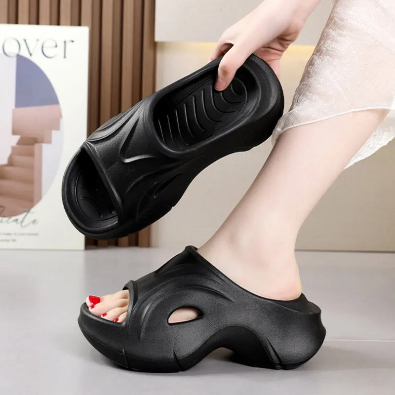Women's white EVA slippers with a thick sole on a sandy beach background