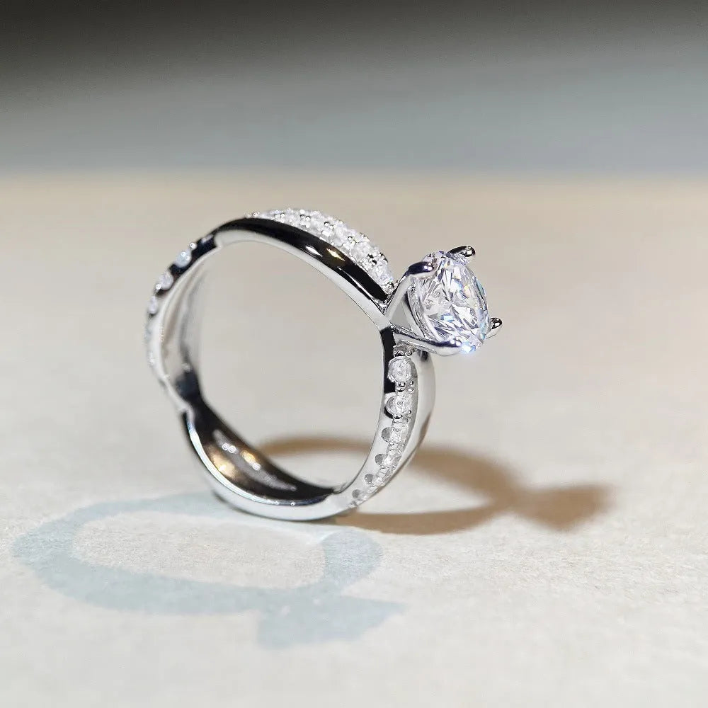 Silver geometric twist band ring with a 1-carat Moissanite stone in a four-claw setting.