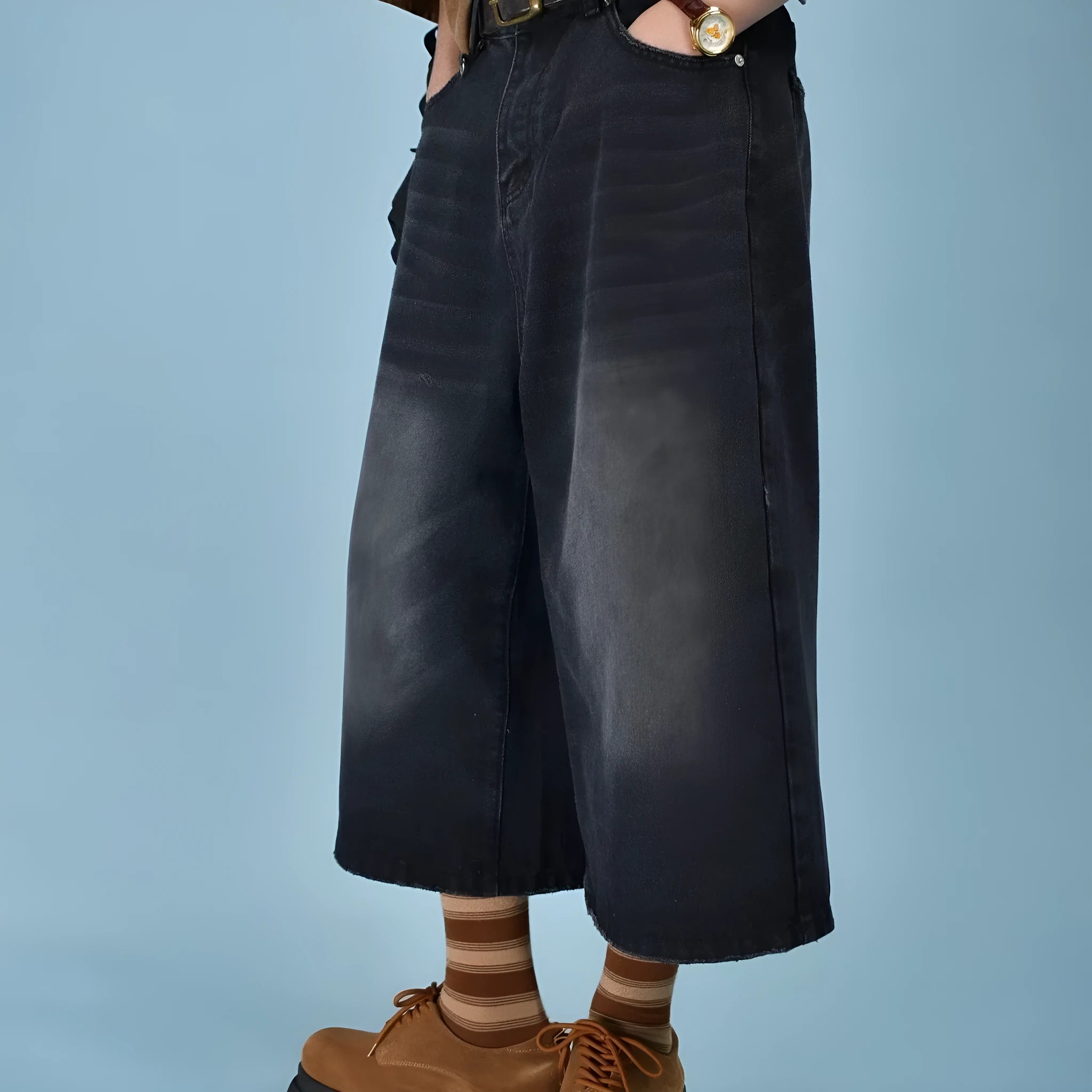 Men's loose straight-leg denim shorts in blue on a plain background