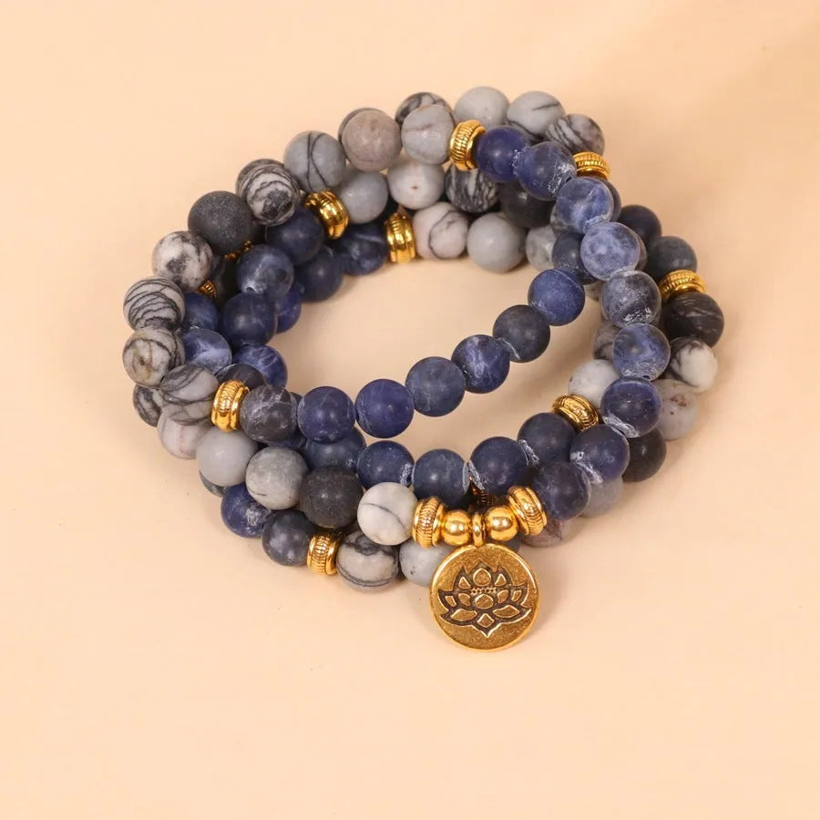 Multi-layer bracelet with blue patterned network stone beads on an alloy base, showing a fresh and sweet natural style.