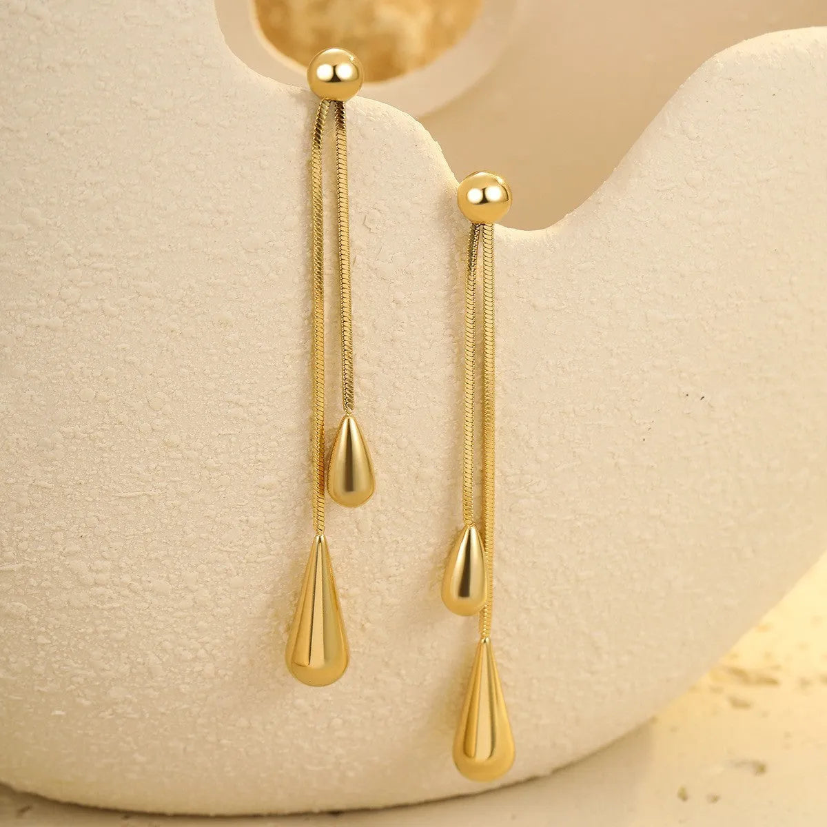Stainless steel tassel water drop earrings with Y-word chain ornament in 18K gold electroplated finish, geometric drop-shaped design
