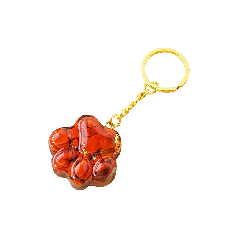 Small natural crystal cat's paw keychain pendant on a metal ring.
