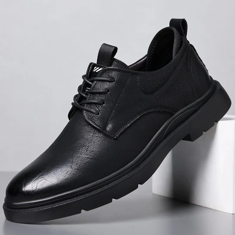 Men's black and brown leather sneakers with rubber sole and decorative sewing line detailing on cowhide upper