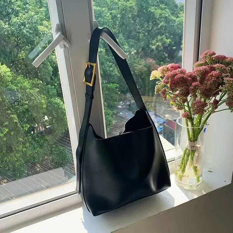 Women's soft PU shoulder bag with swing threads in black or brown colour options