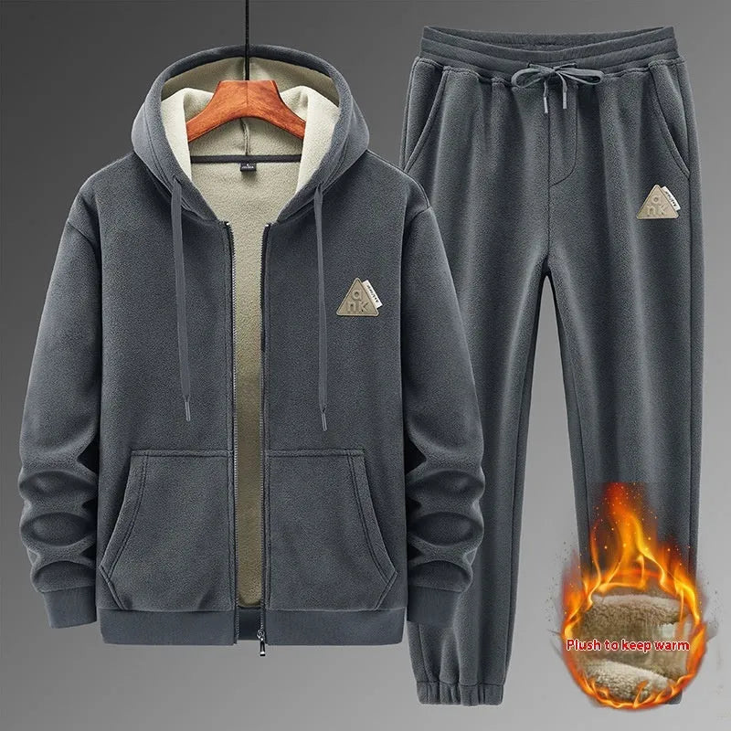 Grey hooded sweater and matching trousers casual sports suit on a hanger.