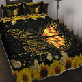 Butterfly and sunflower pattern 3-piece quilt set with 1 quilt and 2 pillow shams on a bed