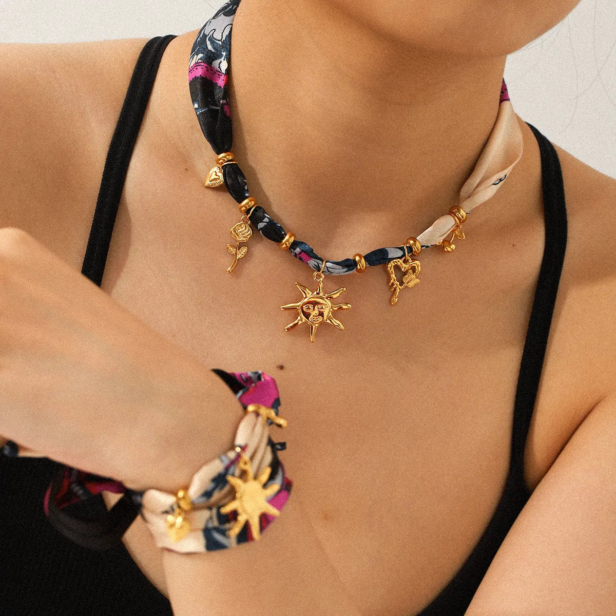 Children's stainless steel sunflower necklace and bracelet set in ins style on a light background