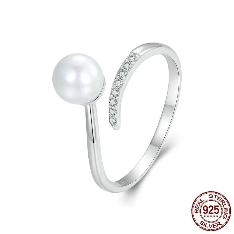 S925 sterling silver adjustable ring with a natural shell pearl on an open loop band.