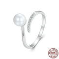 S925 sterling silver adjustable ring with a natural shell pearl on an open loop band.