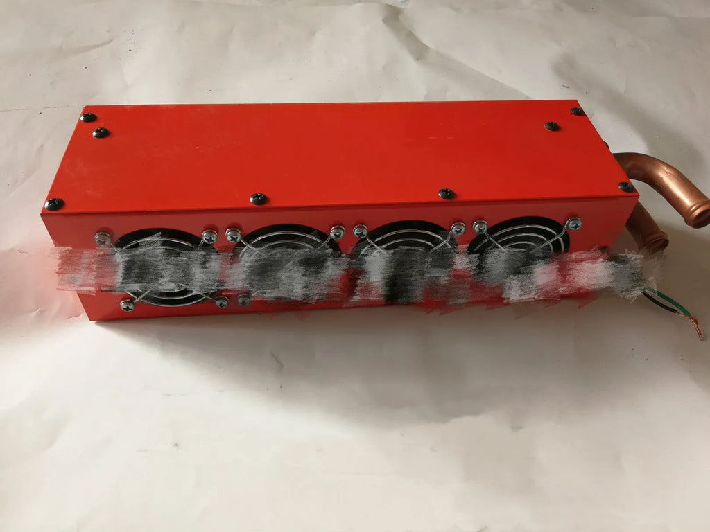 Compact metal car auxiliary heater with copper pipe connections for 12V and 24V vehicle systems.
