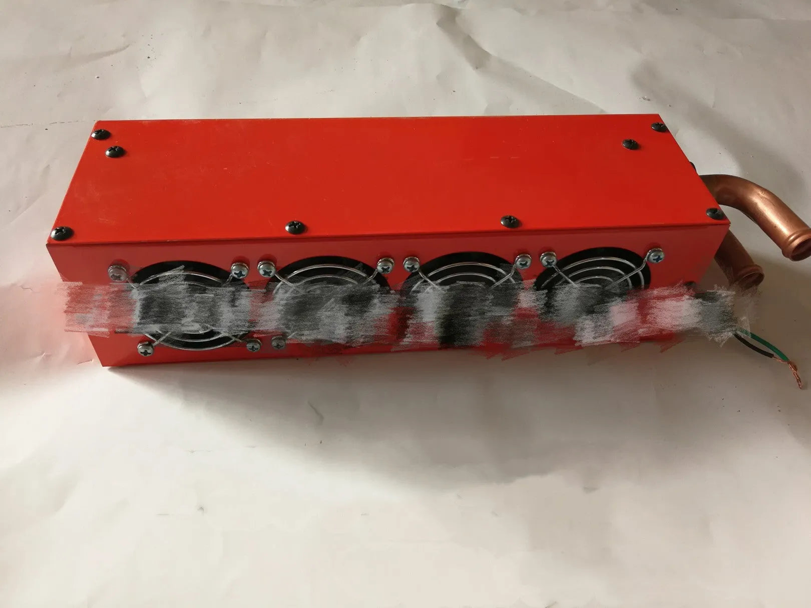 Compact metal car auxiliary heater with copper pipe connections for 12V and 24V vehicle systems.