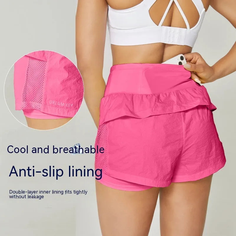 Women's loose fit cotton blend fitness shorts in lemon yellow colour on a hanger