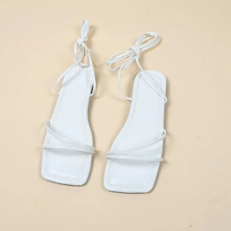 Women's white ankle ring bandage cloth flat sandals with front lace-up and square toe on a rubber sole.