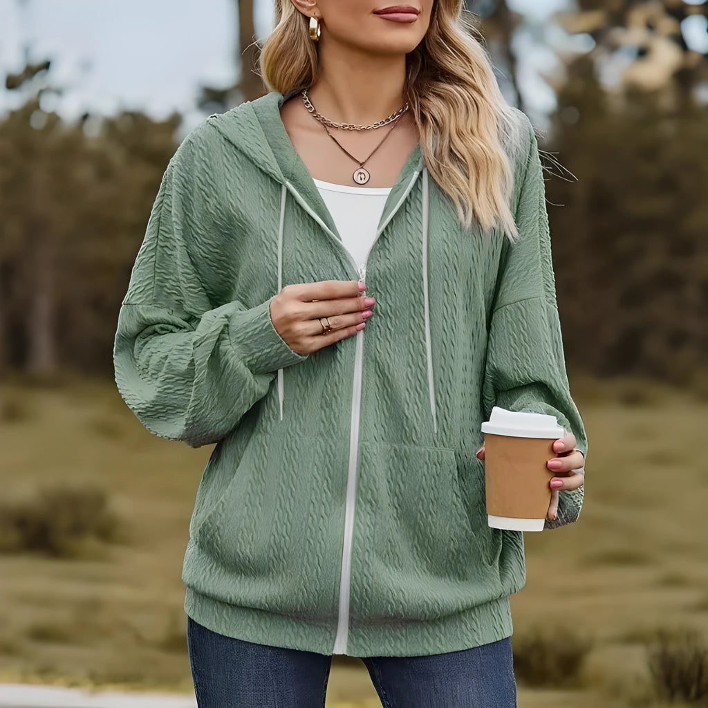 Green loose fit hooded zipper coat for women on a hanger.