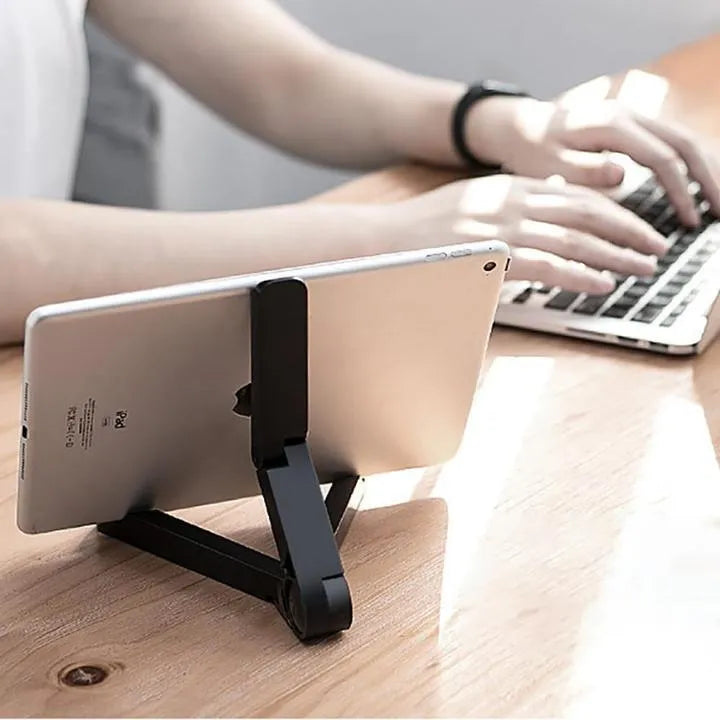 Foldable tablet holder shown in black with smartphone mounted in landscape orientation