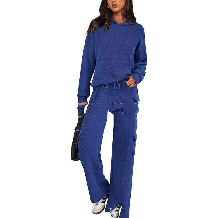 Women's black polyester leisure sports suit set with long sleeves and trousers laid flat.