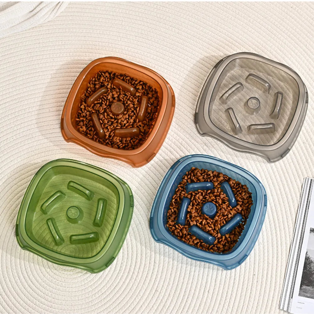 Blue plastic slow feeder dog bowl for anti-choking feeding on a plain surface.