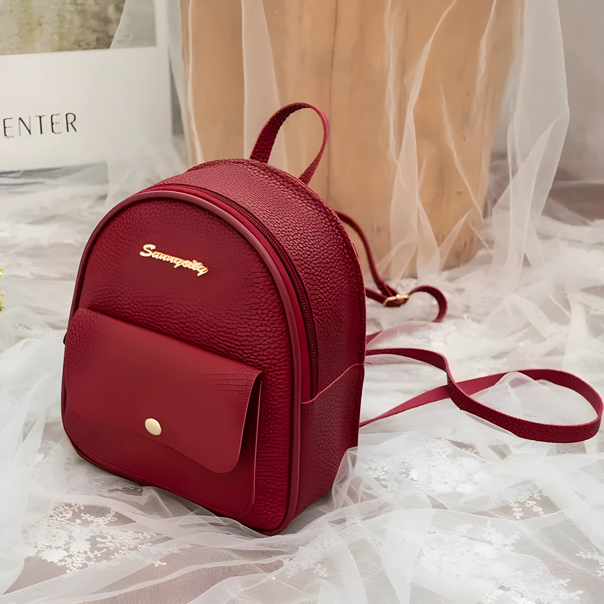 Women's compact black PU bag worn as both a shoulder bag and a small backpack.