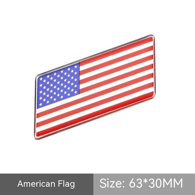 Aluminium parallelogram car sticker showing a national flag design, measuring 6.3 by 3 centimetres.