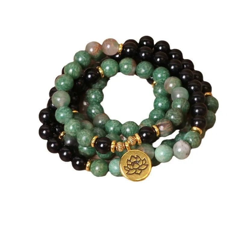 Green and black elastic beaded fashion bracelet with alloy clasp showing adjustable design