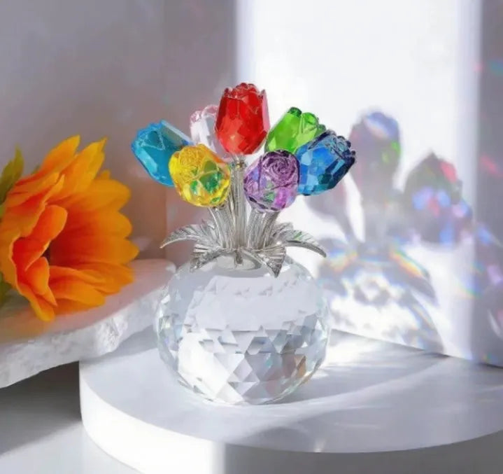 Geometric crystal glass rose ornament in red colour on wooden surface