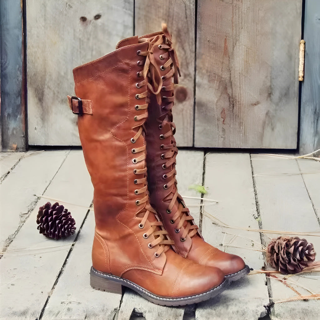 Women's black casual high leg boots with a chunky low heel and round toe on a plain background