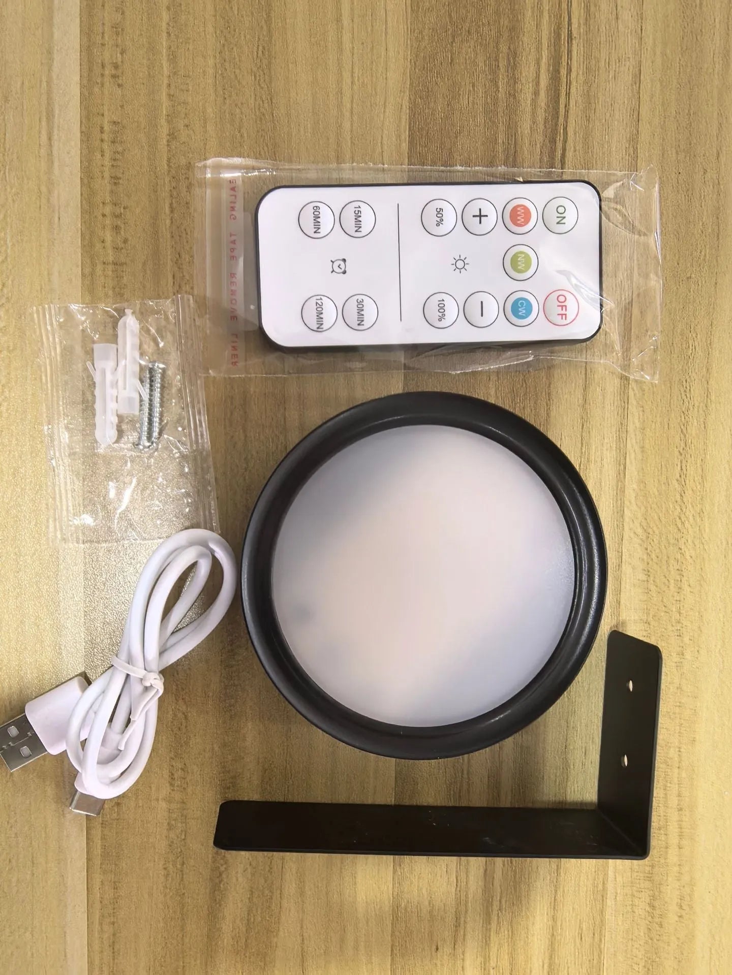 Wireless LED painting lamp with a magnetic mounting belt and remote control in black finish.