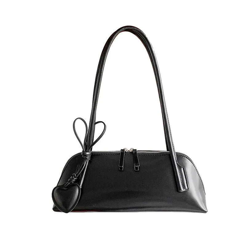 Crossbody shoulder bag in black PU with double straps, horizontal square shape, and visible sewing thread detail on front