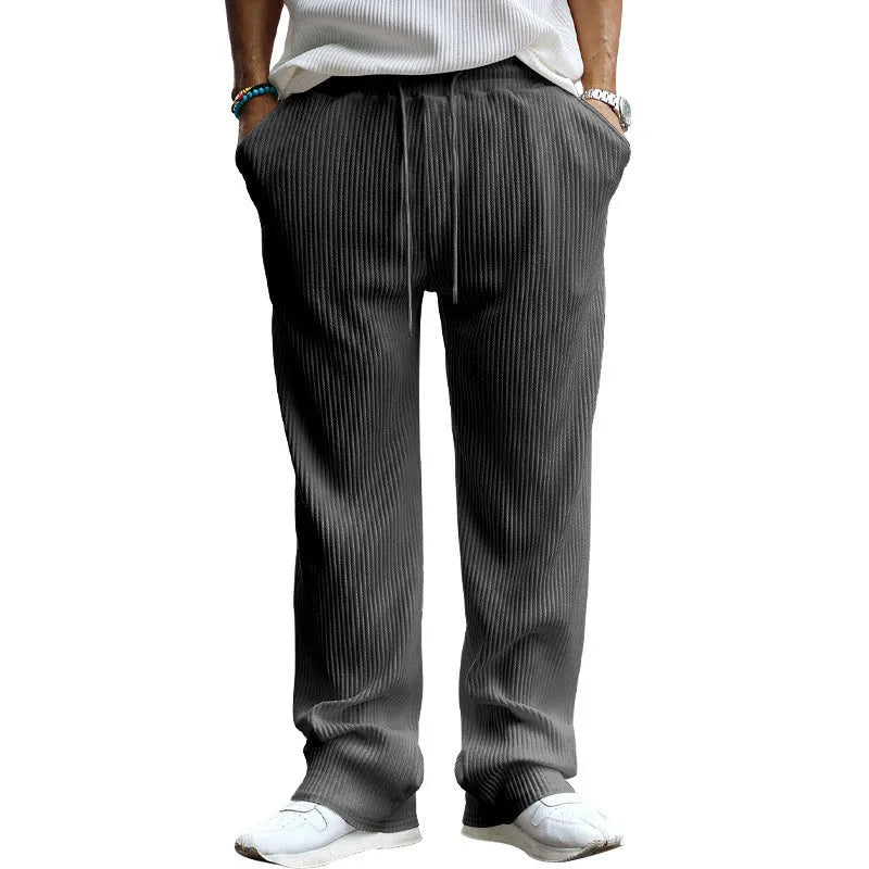 Man wearing loose high-waist striped casual trousers in Army Green, showing the straight leg fit.