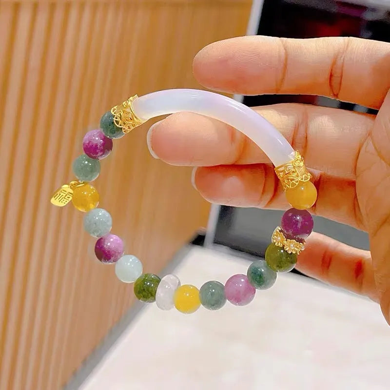 Rainbow colour tourmaline half bracelet for women on a wrist.