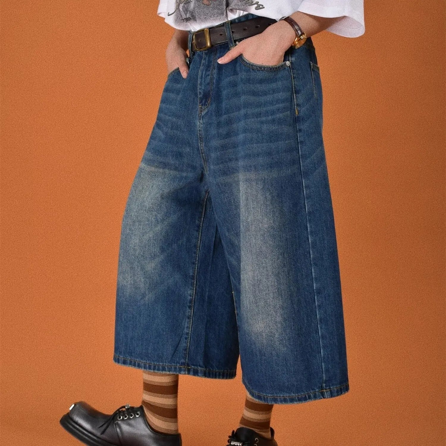 Men's loose straight-leg denim shorts in blue on a plain background
