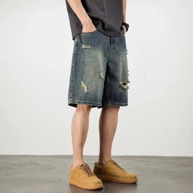 Blue retro loose hole men's denim shorts on a neutral background
