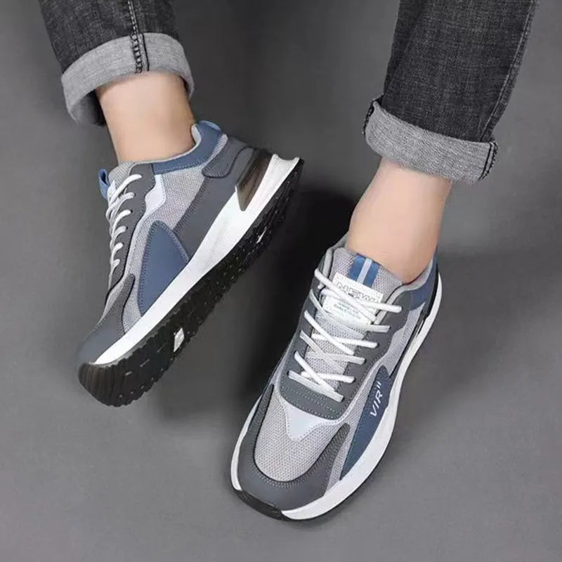 Men's colour block mesh sneakers in black, grey, and white with round toe and flat heel.