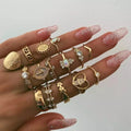 12-piece cross ring set in gold alloy on a flat surface, showing one size design