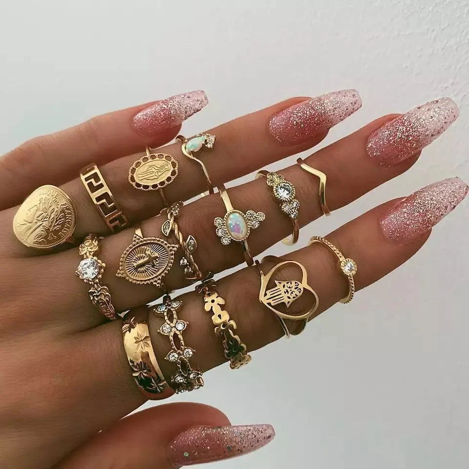 12-piece cross ring set in gold alloy on a flat surface, showing one size design
