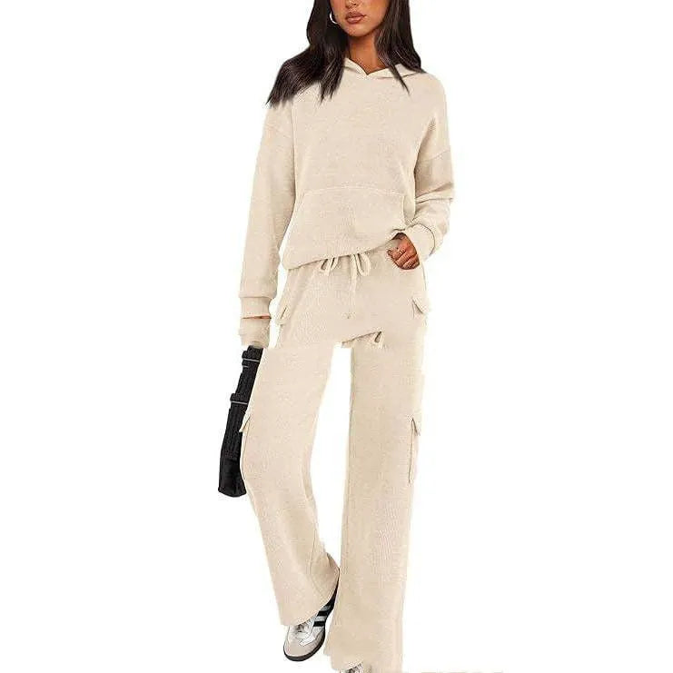 Women's black polyester leisure sports suit set with long sleeves and trousers laid flat.
