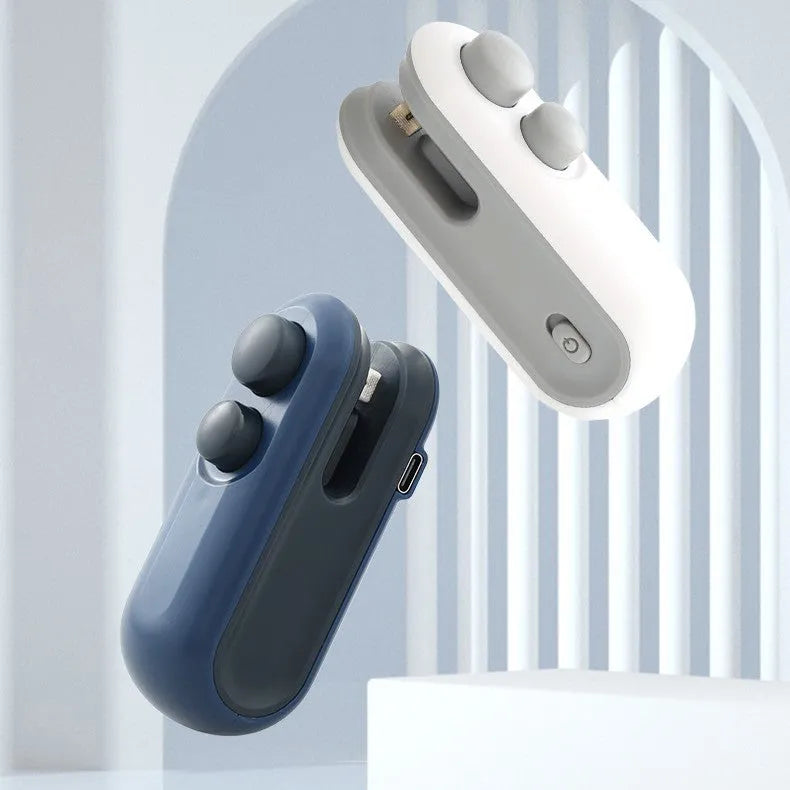 White and blue handheld USB rechargeable heat sealer for sealing food bags with magnetic back.