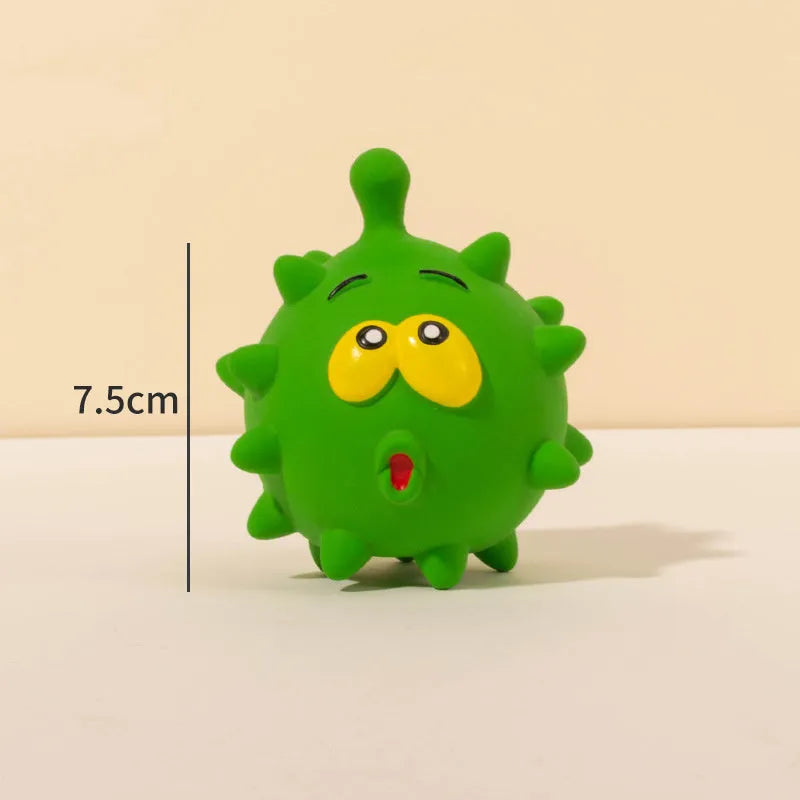 Set of four coloured latex squeaky dog balls with cute faces on a bumpy surface.