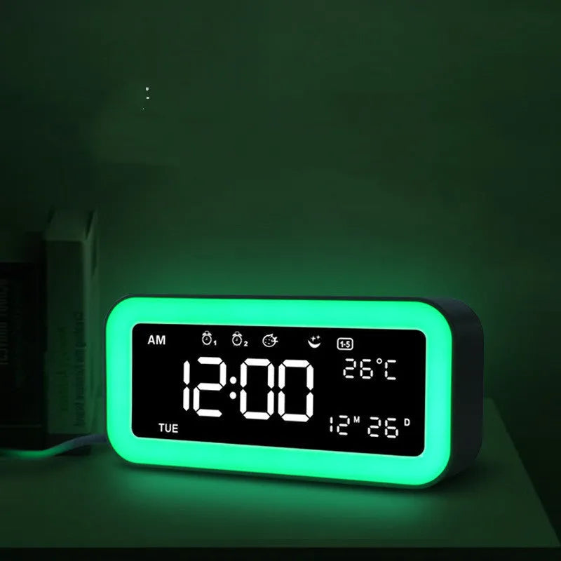 Blue rectangular LED digital alarm clock with multicolour light settings on a wooden surface.