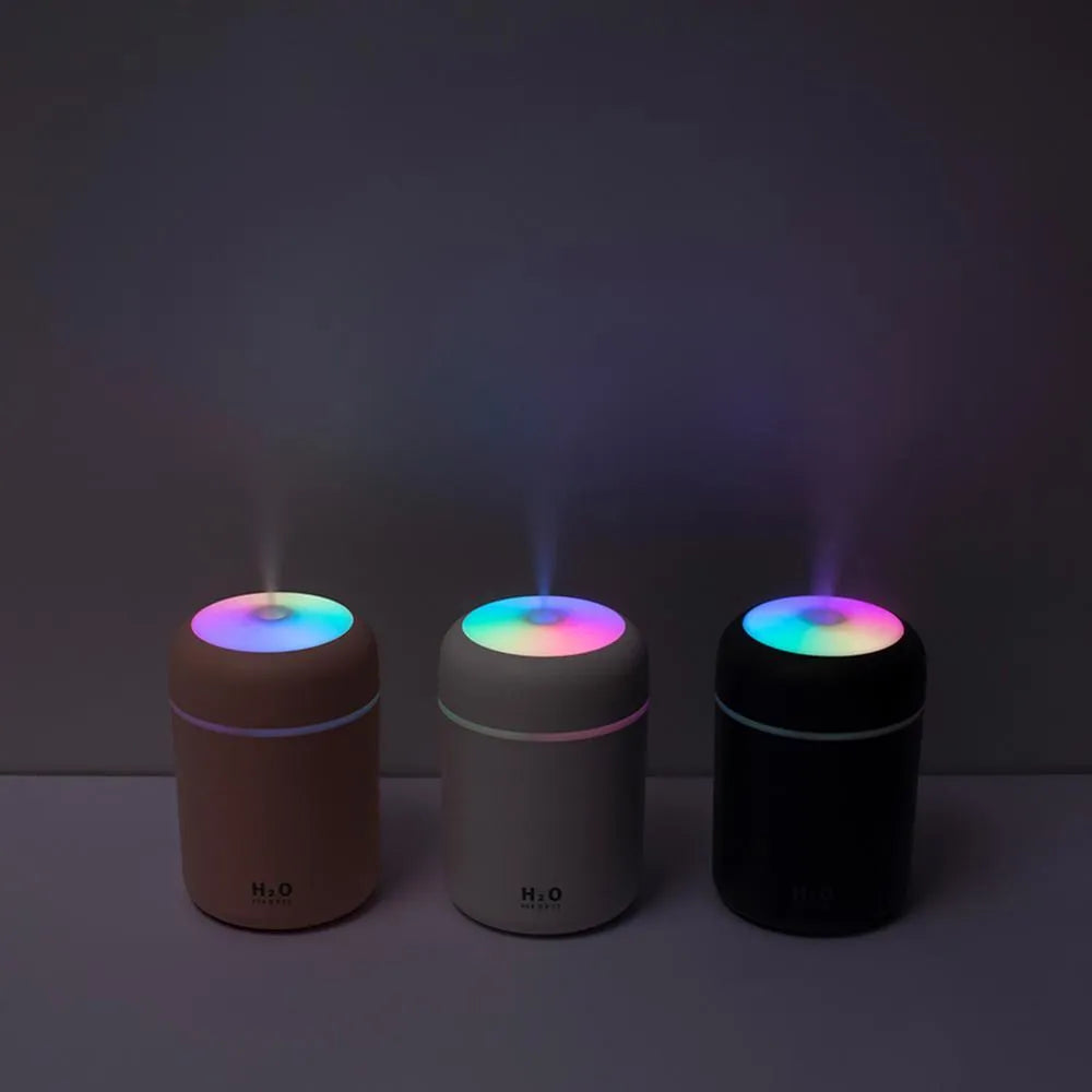 Pink USB desktop humidifier with colourful LED lights and 300ml water tank on wooden desk