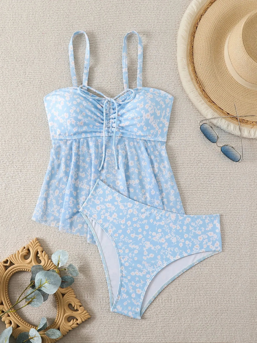 Light blue floral women's swimsuit set with shoulder straps and backless design, available in sizes S to XL