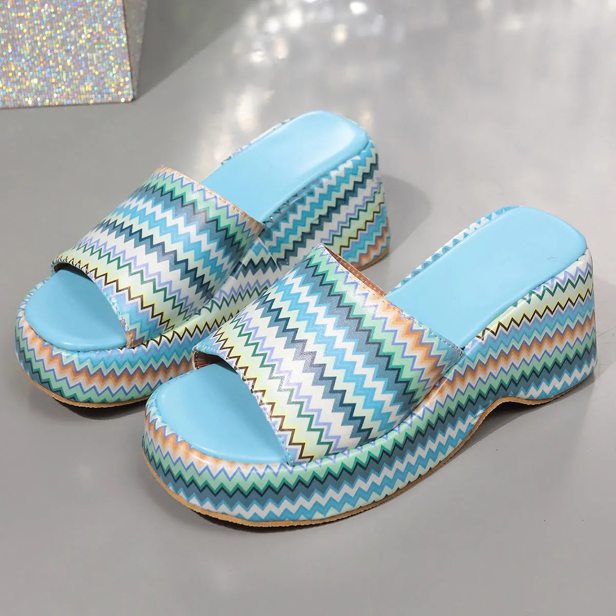 Women's beige wedge sandals with a blue and pink wave print design, thick rubber sole, and fish mouth toe.