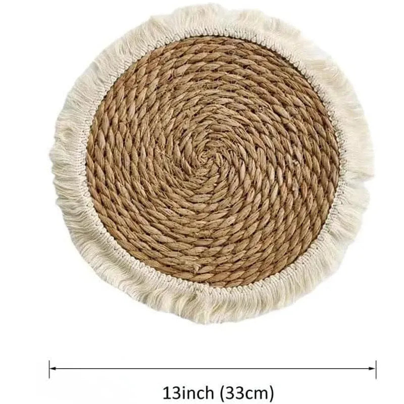 Round Japanese straw placemat with corn rope tassel detailing on wooden table