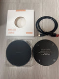 Black frosted 15W wireless charger on a desk with a Type-C cable connected
